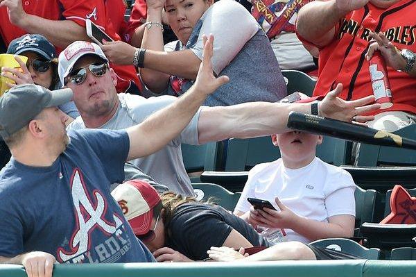 Fast-acting-dad-deflects-baseball-bat-headed-for-sons-face